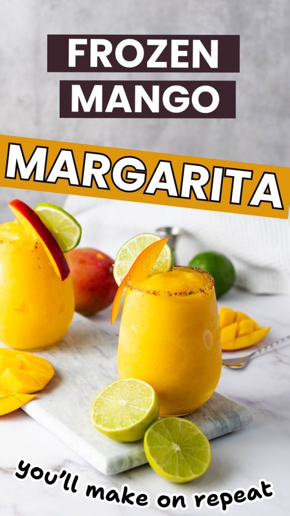 Two glasses of Frozen Mango Margarita, garnished with lime and mango slices, sit among fresh fruit on a marble board. Bold text reads: Frozen Mango Margarita you’ll make on repeat.