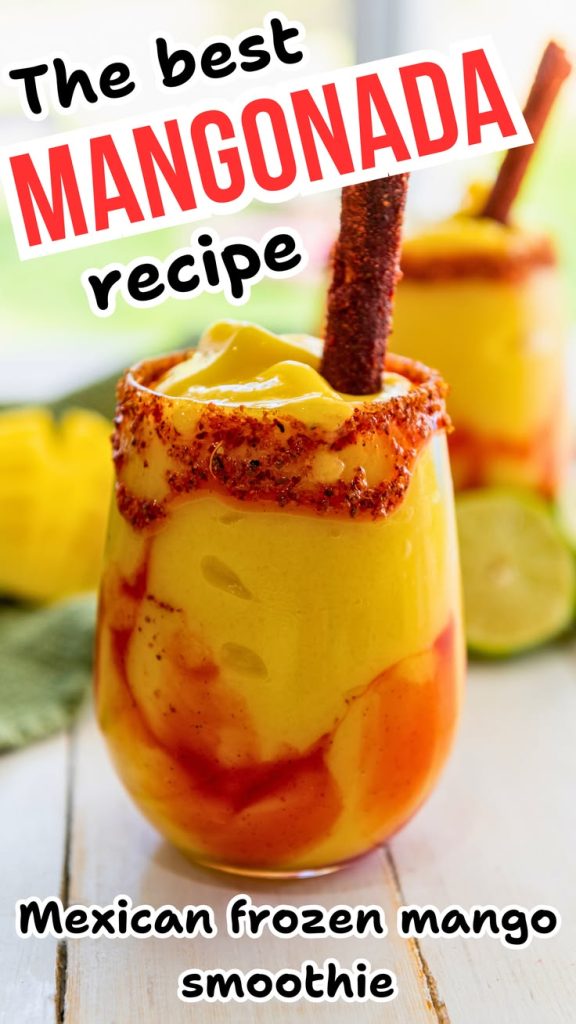 A glass of frozen mangonada topped with a tamarind candy stick, chamoy, and chili powder. Text reads: The best easy mangonada recipe. Mexican frozen mango smoothie. Another sweet and spicy drink sits in the background.