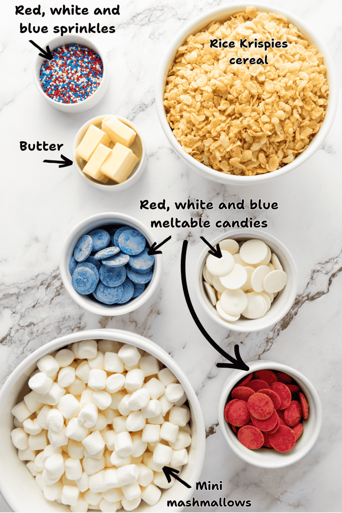 Bowls on a marble surface containing ingredients for Rice Krispie Treats—red, white, and blue sprinkles, cereal, butter, colored meltable candies, and mini marshmallows—perfect for festive 4th of July desserts. Each bowl is labeled with text.