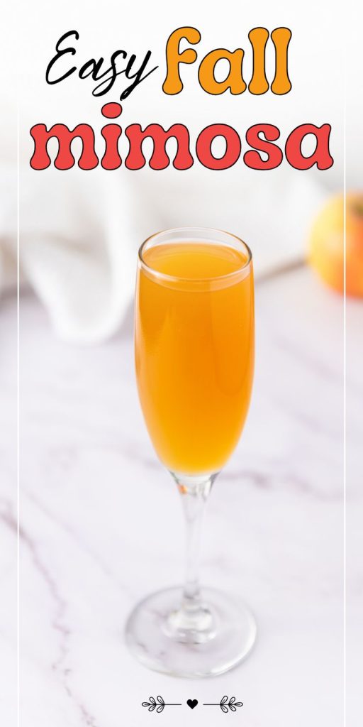 A champagne flute filled with orange Apple Cider Mimosa stands on a marble surface. Bold text above reads Easy Fall Mimosa. A blurred apple and white cloth are in the background.