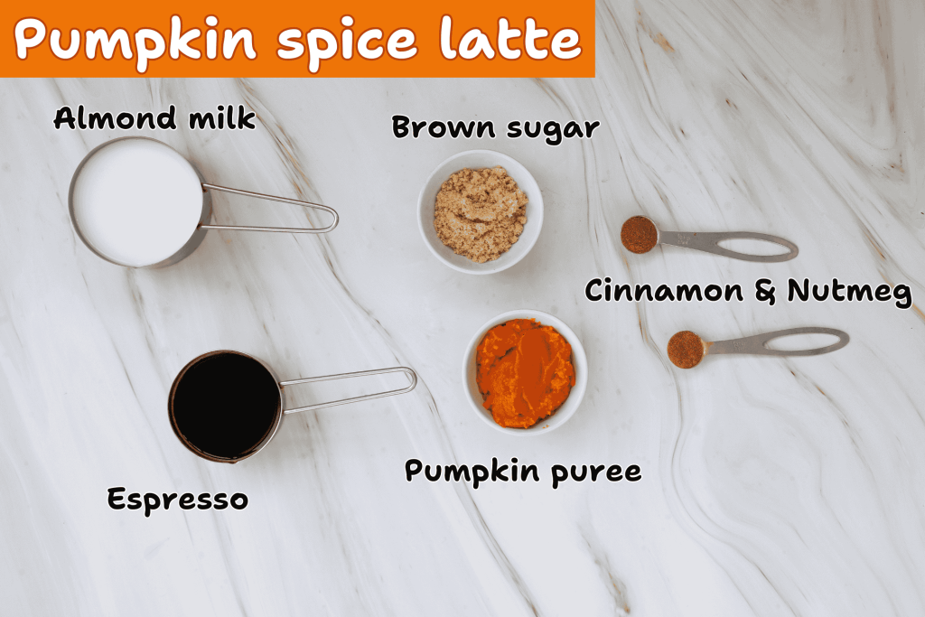 A marble surface displays labeled ingredients for a pumpkin spice latte with almond milk: almond milk in a measuring cup, brown sugar in a bowl, cinnamon and nutmeg on spoons, espresso in a cup, and pumpkin puree in a bowl.