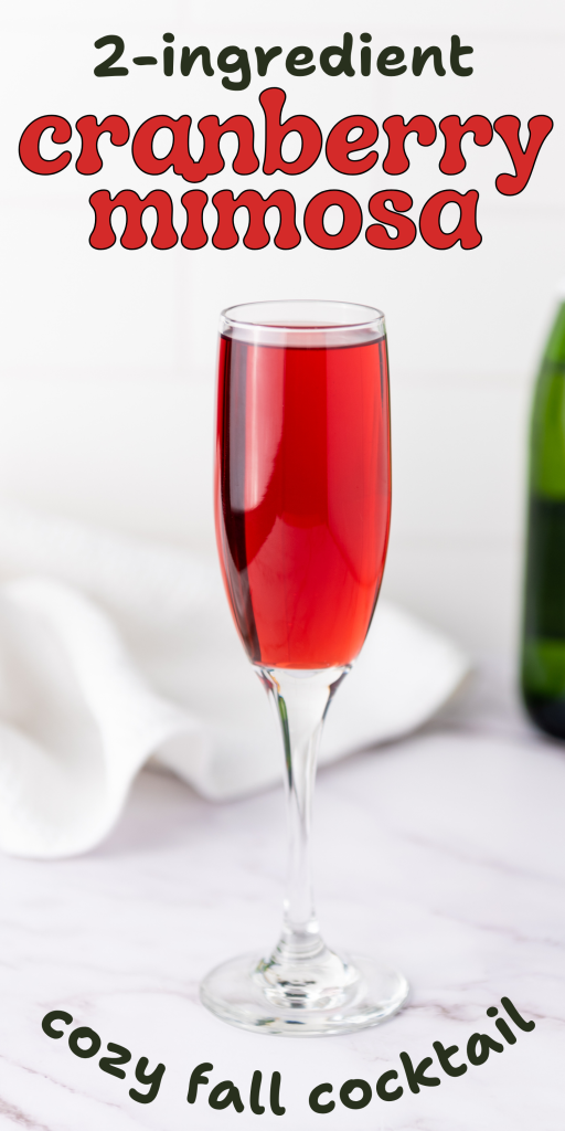A champagne flute filled with bright red mimosas with cranberry juice sits on a white surface. Text reads: 2-ingredient cranberry mimosa and cozy fall cocktail. A green bottle and white towel are blurred in the background.
