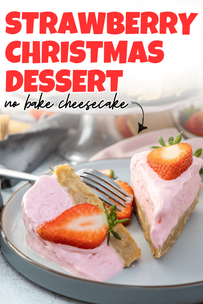A plate with two slices of christmas strawberry cheesecake, each topped with fresh strawberries. A fork rests on the plate. Bold text above reads “Strawberry Christmas Dessert no bake cheesecake.”.