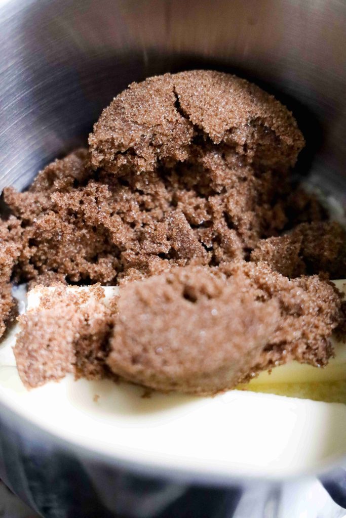 A close-up of brown sugar and a stick of butter in a metal mixing bowl, ready to be combined for baking the perfect Valentine’s Day Bark.