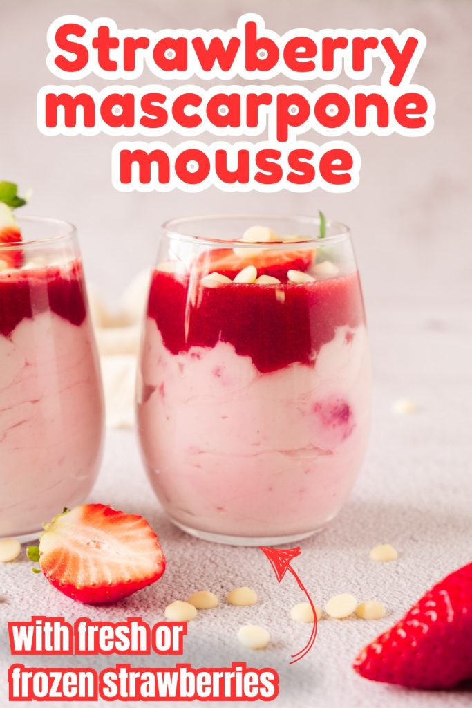 Two glasses of strawberry mascarpone dessert mousse, topped with strawberry sauce and white chocolate chips, sit on a light surface. A sliced strawberry and white chocolate chips are scattered around. Text reads “Strawberry mascarpone mousse.”.