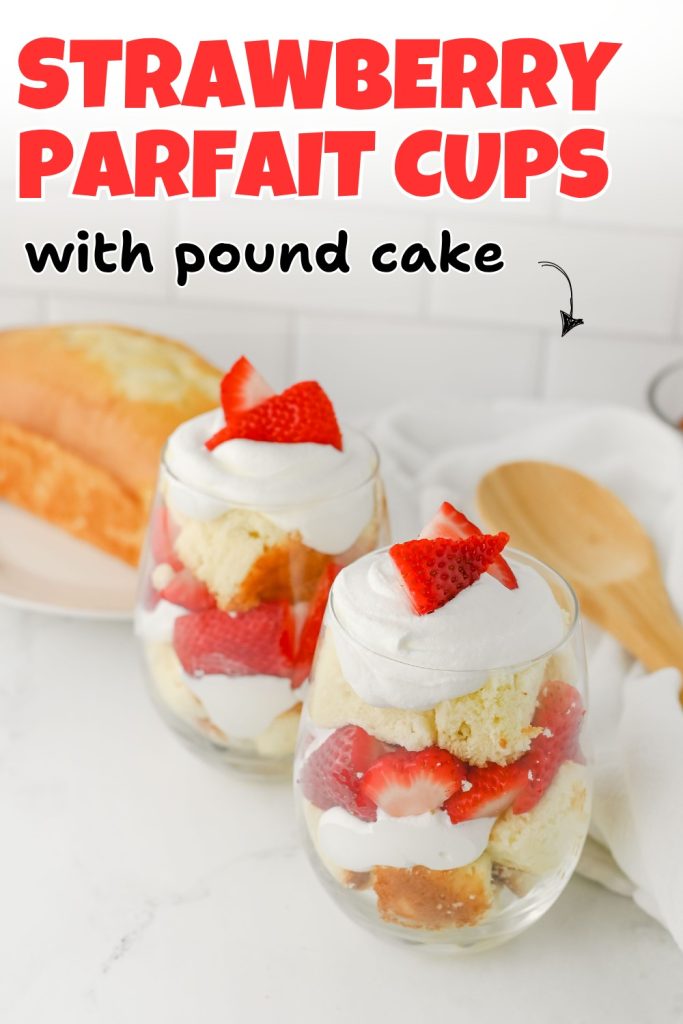 Two glass cups filled with layers of strawberry parfait with pound cake, whipped cream, and fresh strawberries sit on a white surface. A wooden spoon and a plate with more pound cake are in the background. Text reads: Strawberry Parfait Cups with Pound Cake.