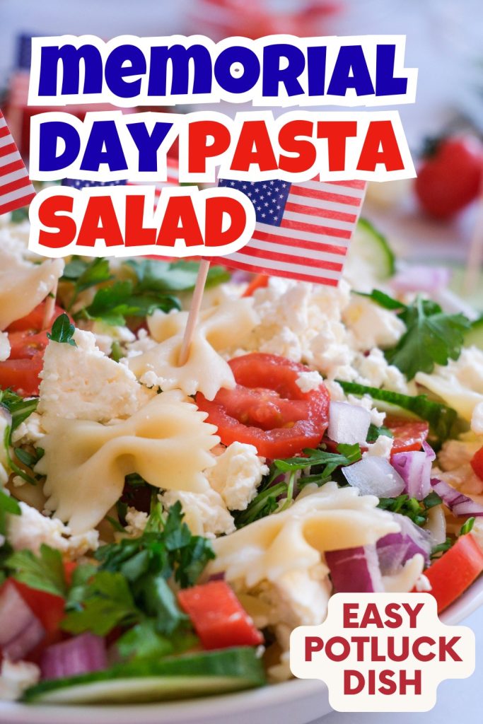 A close-up of a colorful Patriotic Pasta Salad for Memorial Day with bowtie pasta, tomatoes, onion, greens, and cheese, garnished with mini American flags. Text reads Memorial Day Pasta Salad and Easy Potluck Dish.