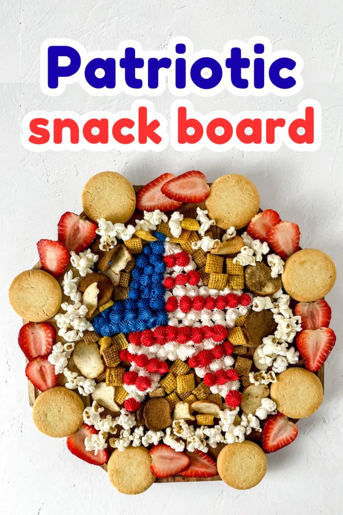 A round patriotic snack board arranged with cookies, popcorn, strawberries, and a central star made of red, white, and blue frosting, topped with the bold, colorful text “Patriotic snack board” for a festive touch.