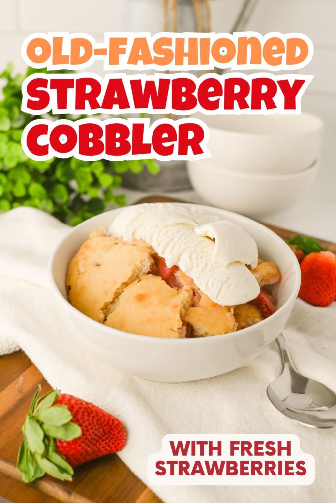A bowl of Old-Fashioned Strawberry Cobbler topped with vanilla ice cream sits on a white cloth, surrounded by fresh strawberries and a spoon, with text reading Old-Fashioned Strawberry Cobbler Recipe with Fresh Strawberries.