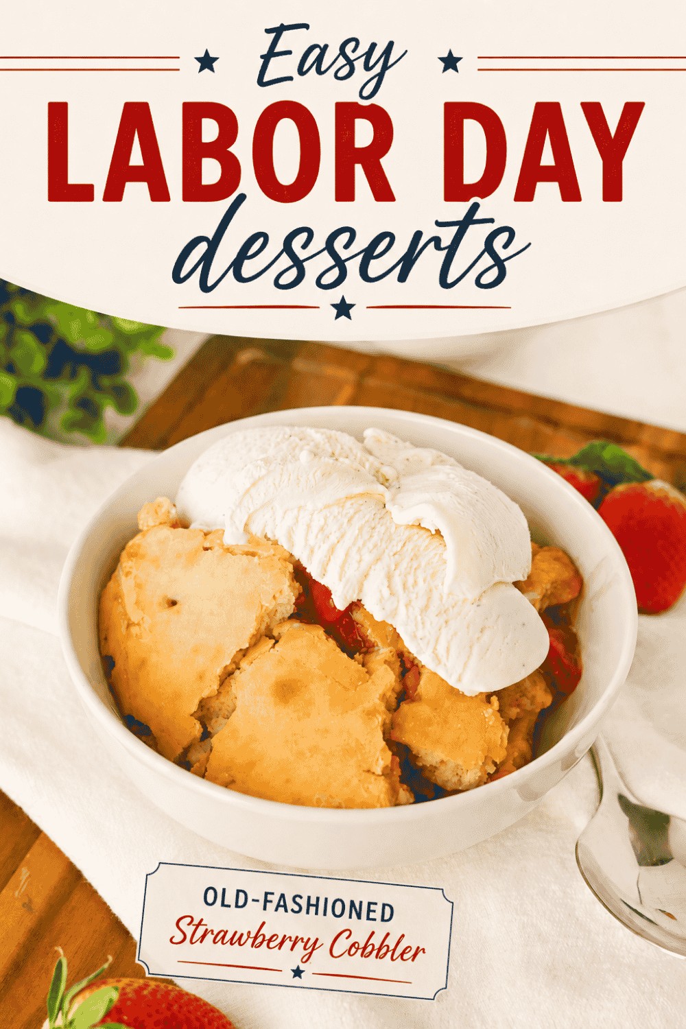 A bowl of strawberry cobbler topped with vanilla ice cream sits on a table, perfectly capturing the spirit of Easy Labor Day Desserts. Text above reads, “Easy Labor Day desserts,” and below, “Old-Fashioned Strawberry Cobbler.” Strawberries and a spoon are nearby.