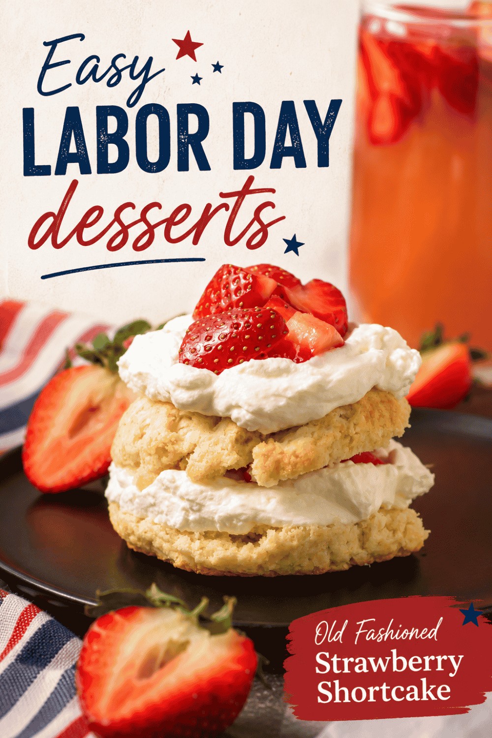 A strawberry shortcake topped with whipped cream and fresh strawberries sits on a dark plate, with a drink and a striped napkin nearby. Text on the image reads “Easy Labor Day Desserts” and “Old Fashioned Strawberry Shortcake,” making it the perfect treat for your holiday celebration.